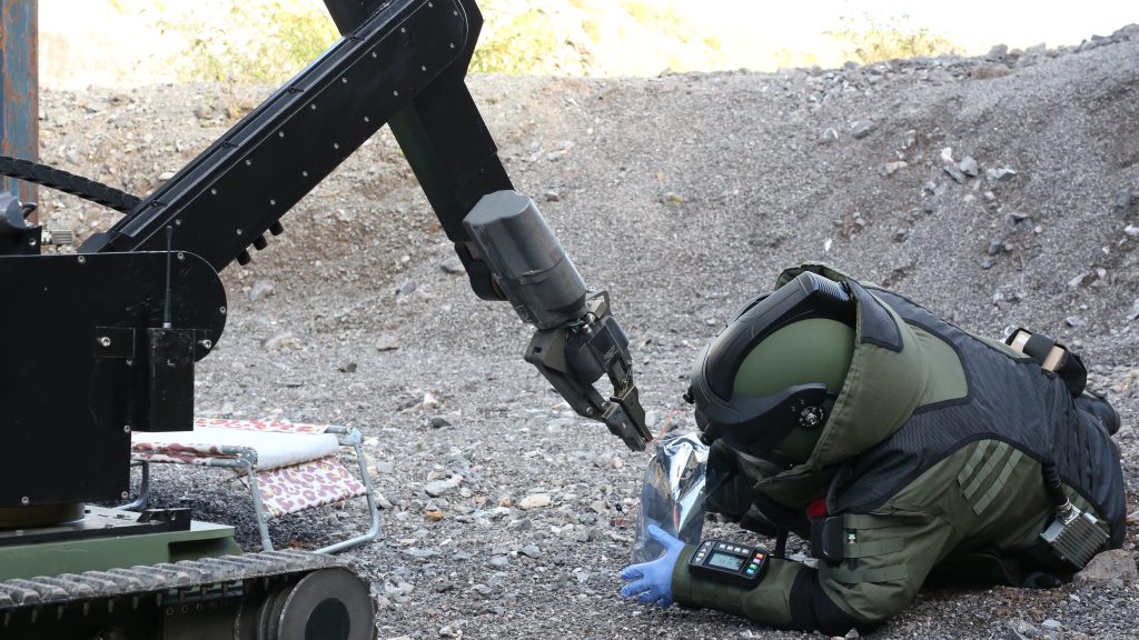 A bomb tech and ROV engaged in an IEDD operation