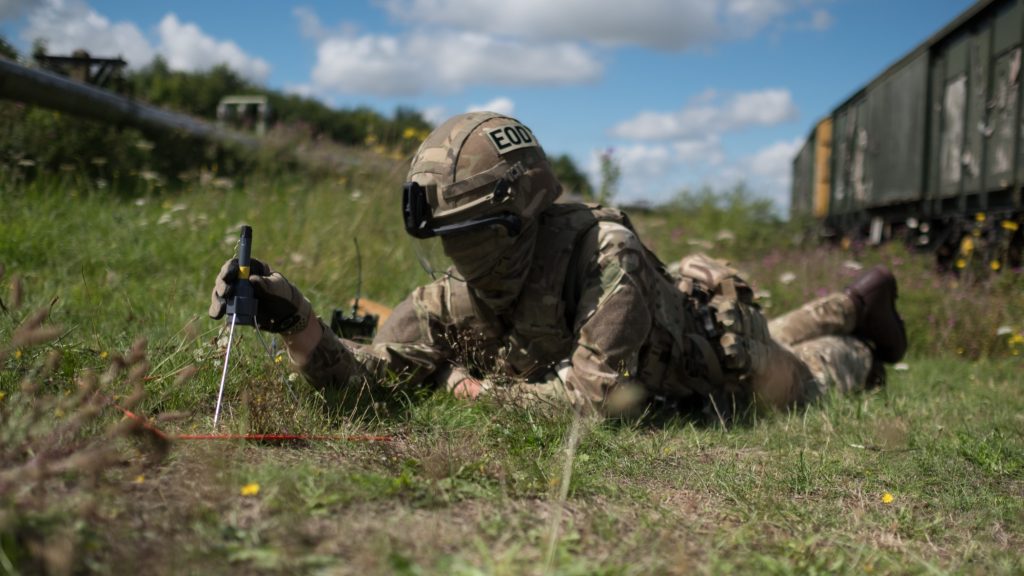 An EOD operator positions an Alford Vulcan shaped charge over UXO target