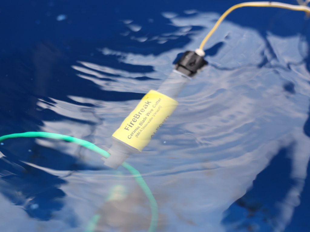 Underwater Firebreak positioned against command wires in water