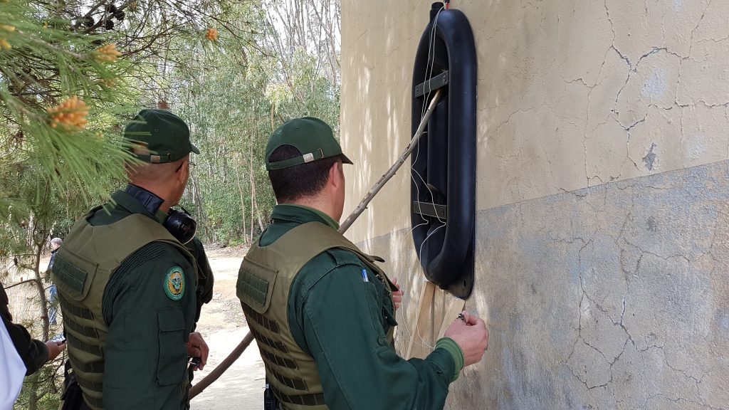 Law enforcement personnel watch a demo of Alford Gatecrasher breaching charge