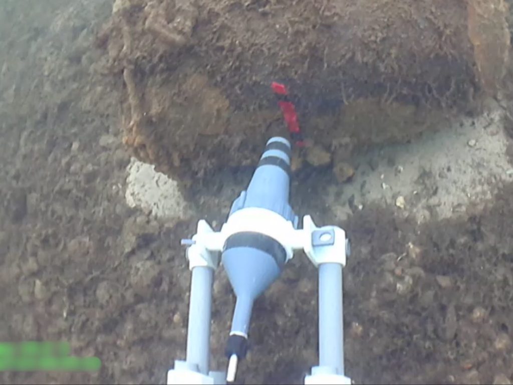 Close up of REDS positioning Pluton shaped charge against underwater UXO