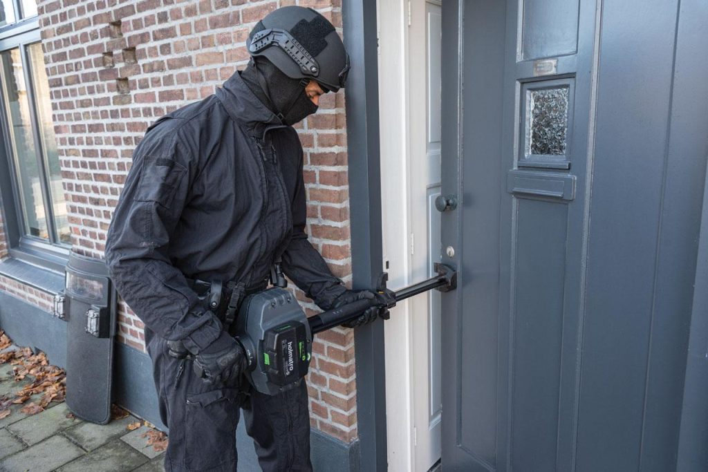 Operator using Holmatro door ram GDR200STEVO3 to open a door