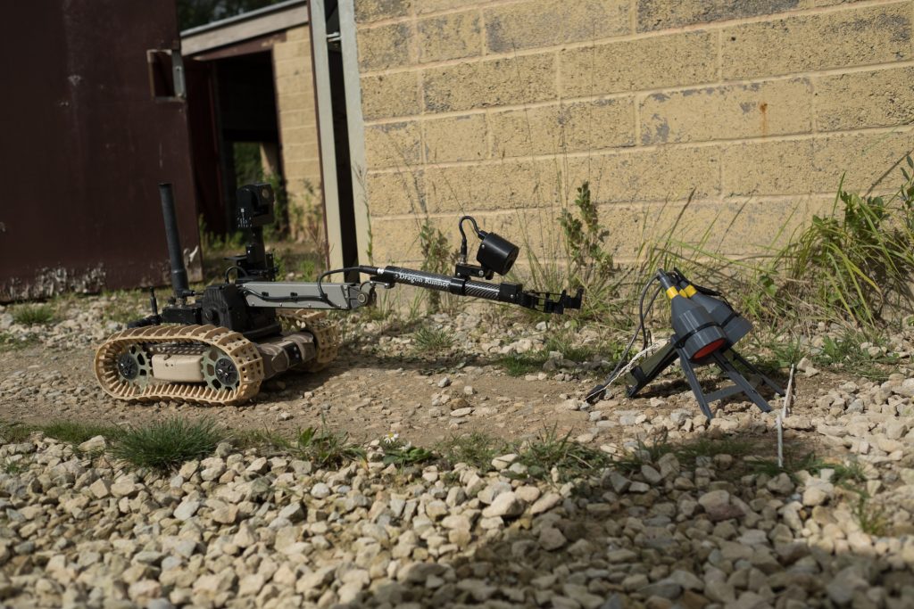 A robot positions an array of Pluton shaped charges against UXO